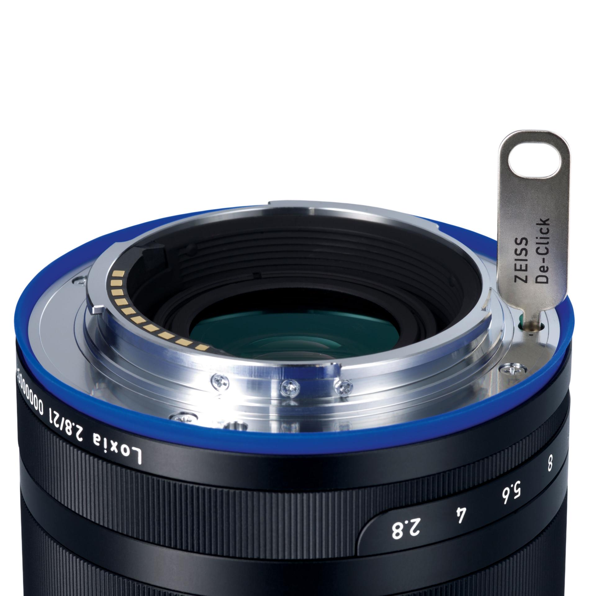 Close-up of a ZEISS camera lens with a calibration tool inserted into the mount.
