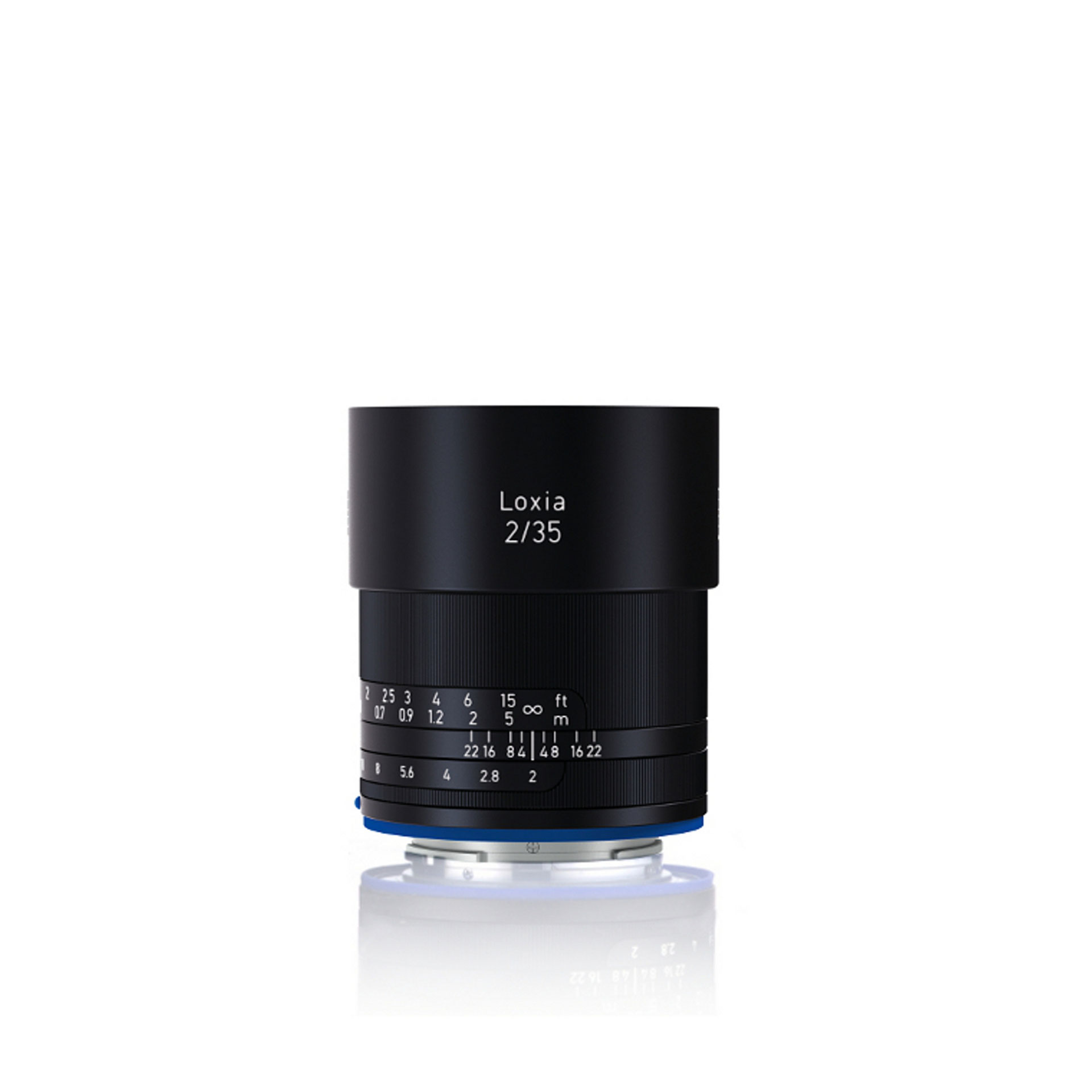 Black ZEISS Loxia 2/35 camera lens standing upright on a white background.