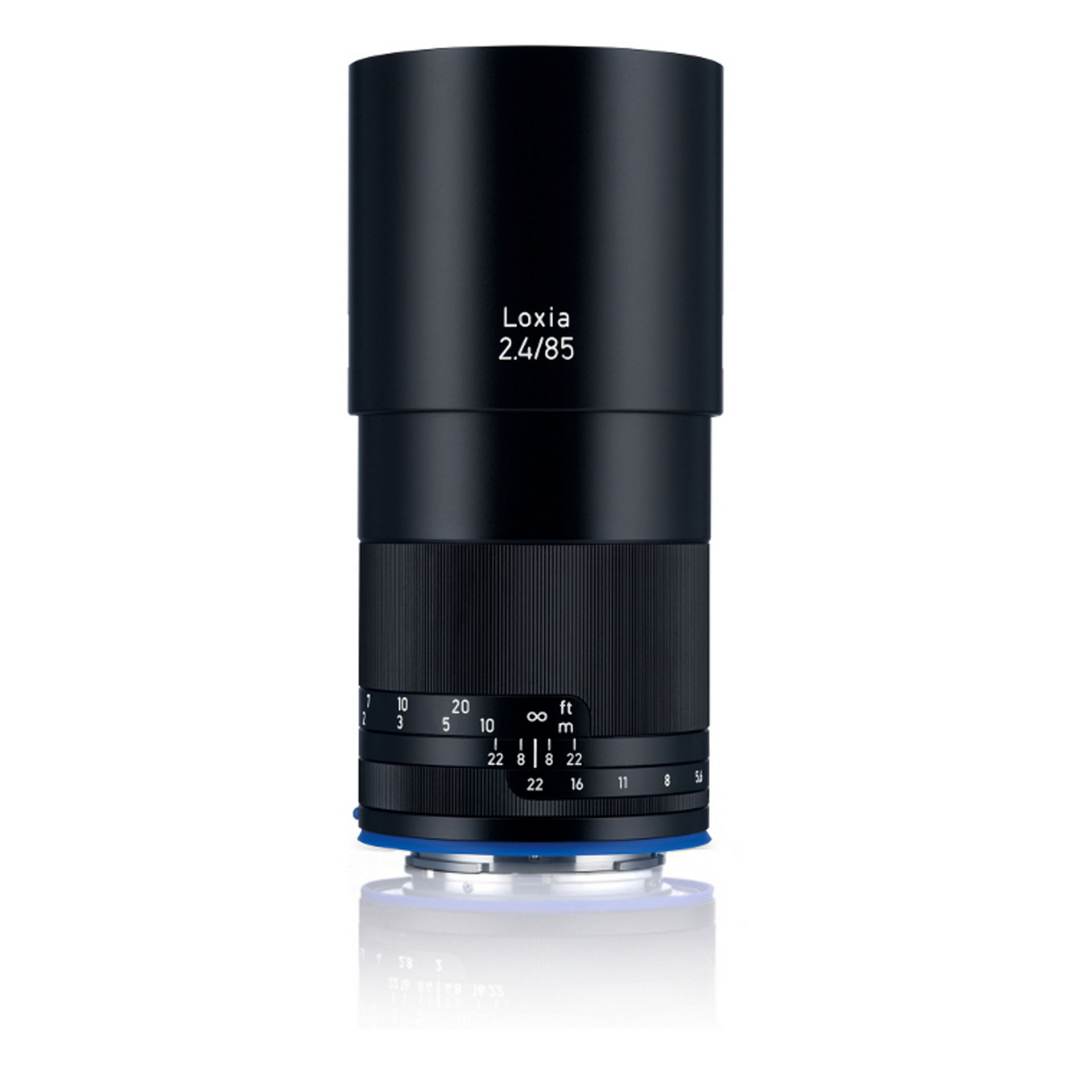 Black ZEISS Loxia 2.4/85 camera lens standing upright on a white background.