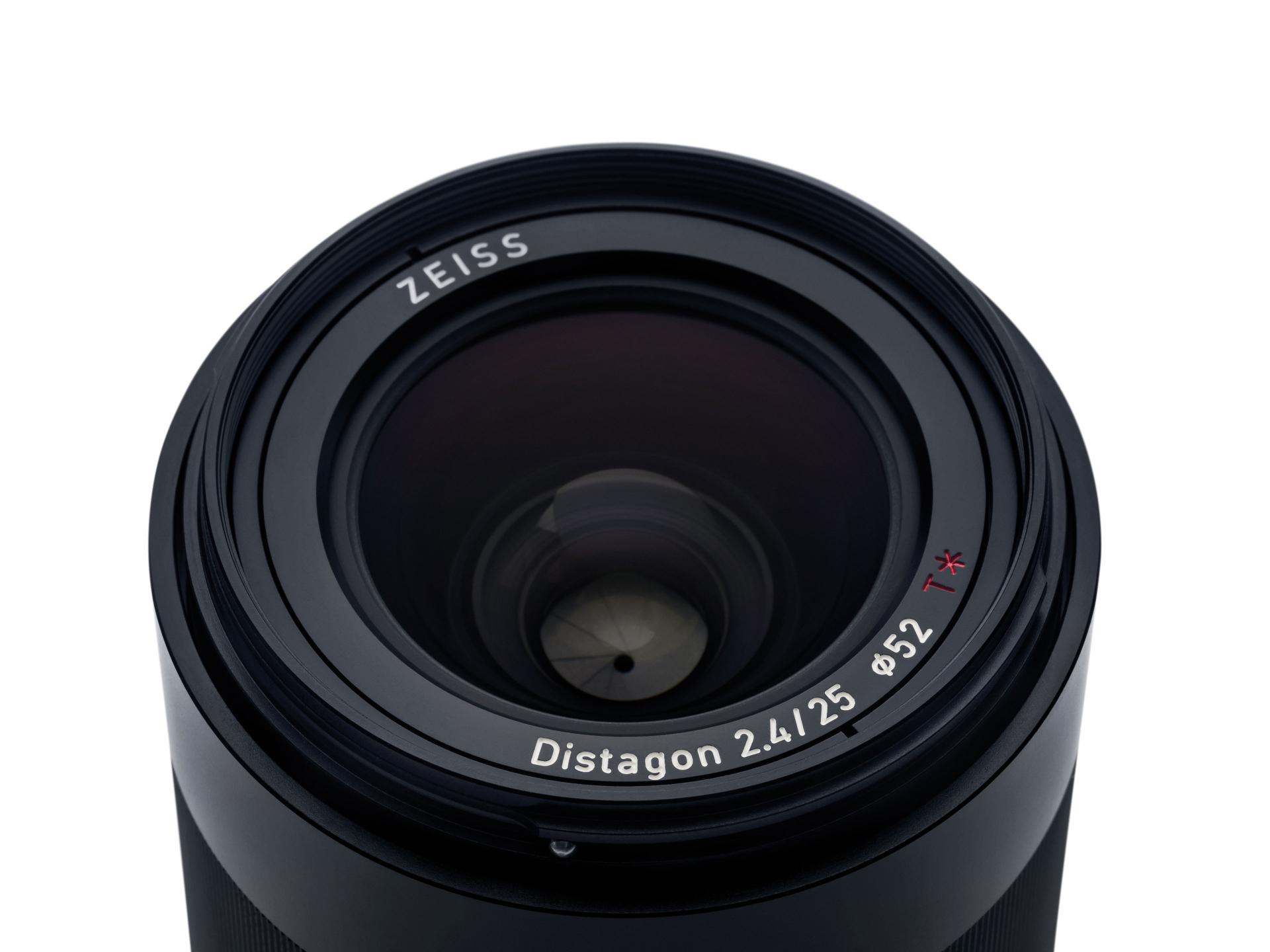 Close-up view of a ZEISS Distagon 2.4/25 camera lens showcasing the front glass element and detailed lens markings.