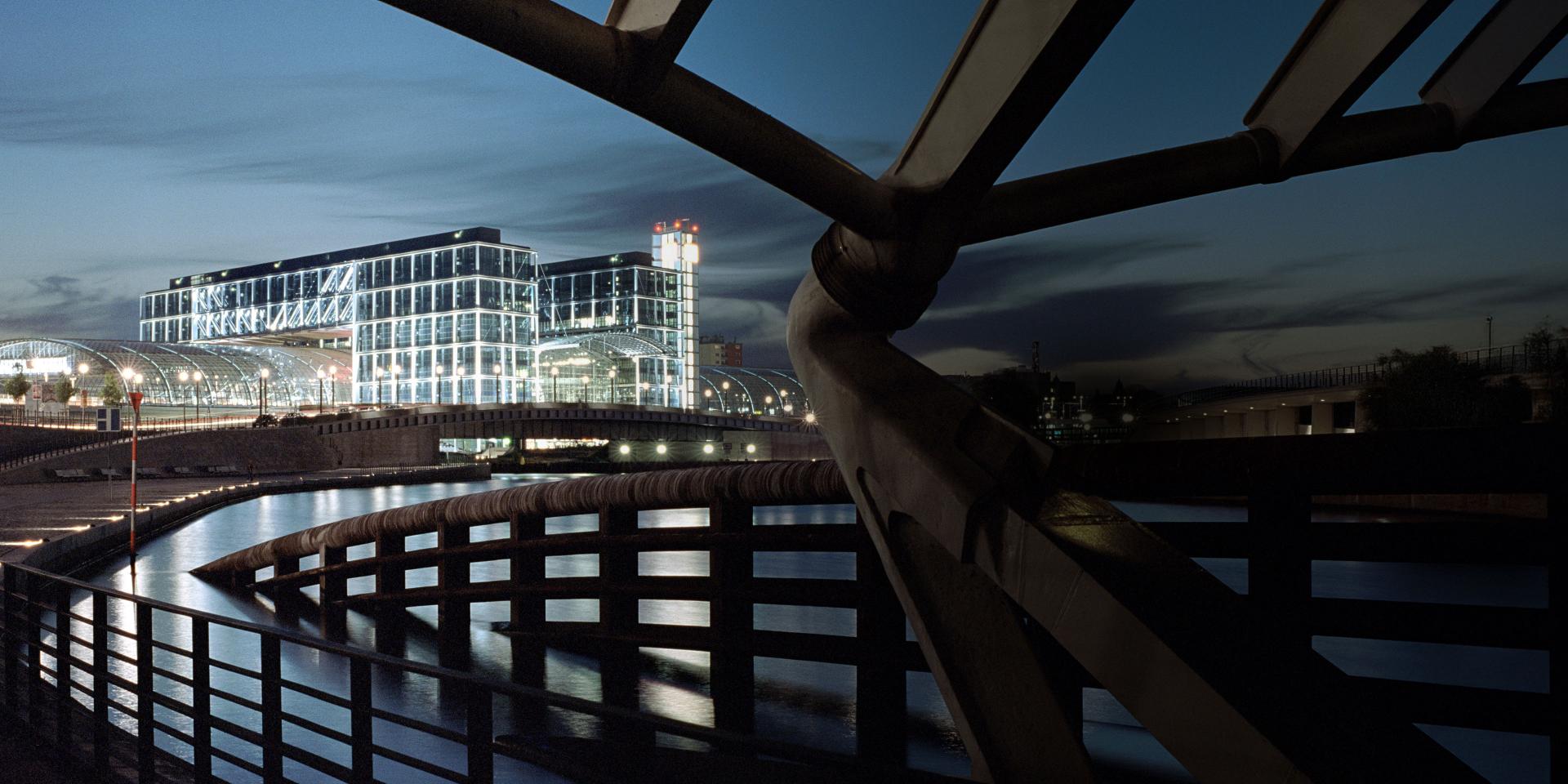 A striking nighttime cityscape captures the illuminated architecture and reflective waterways, showcasing the clarity and low-light performance of ZEISS optics.