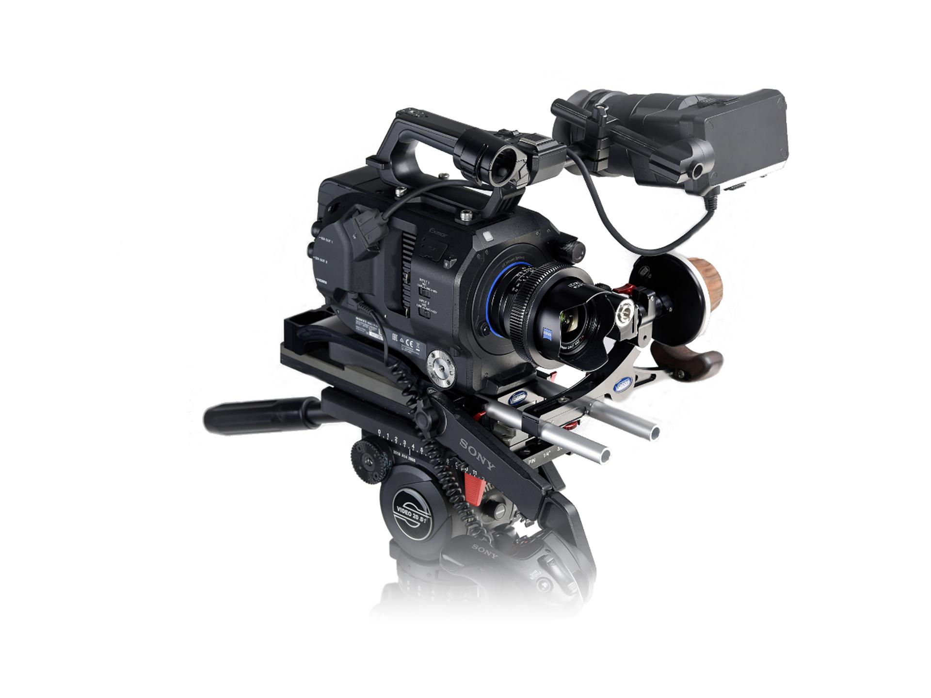 Professional cinema camera setup featuring a ZEISS lens mounted on a rig with various video production accessories.