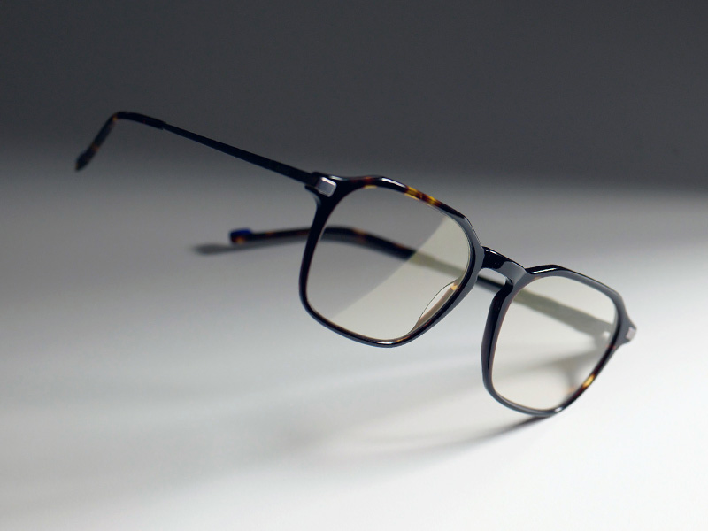 Een afbeelding van heldere brillenglazen met de subtiele goudkleurige glans van ZEISS DuraVision Gold UV in een bruin montuur.