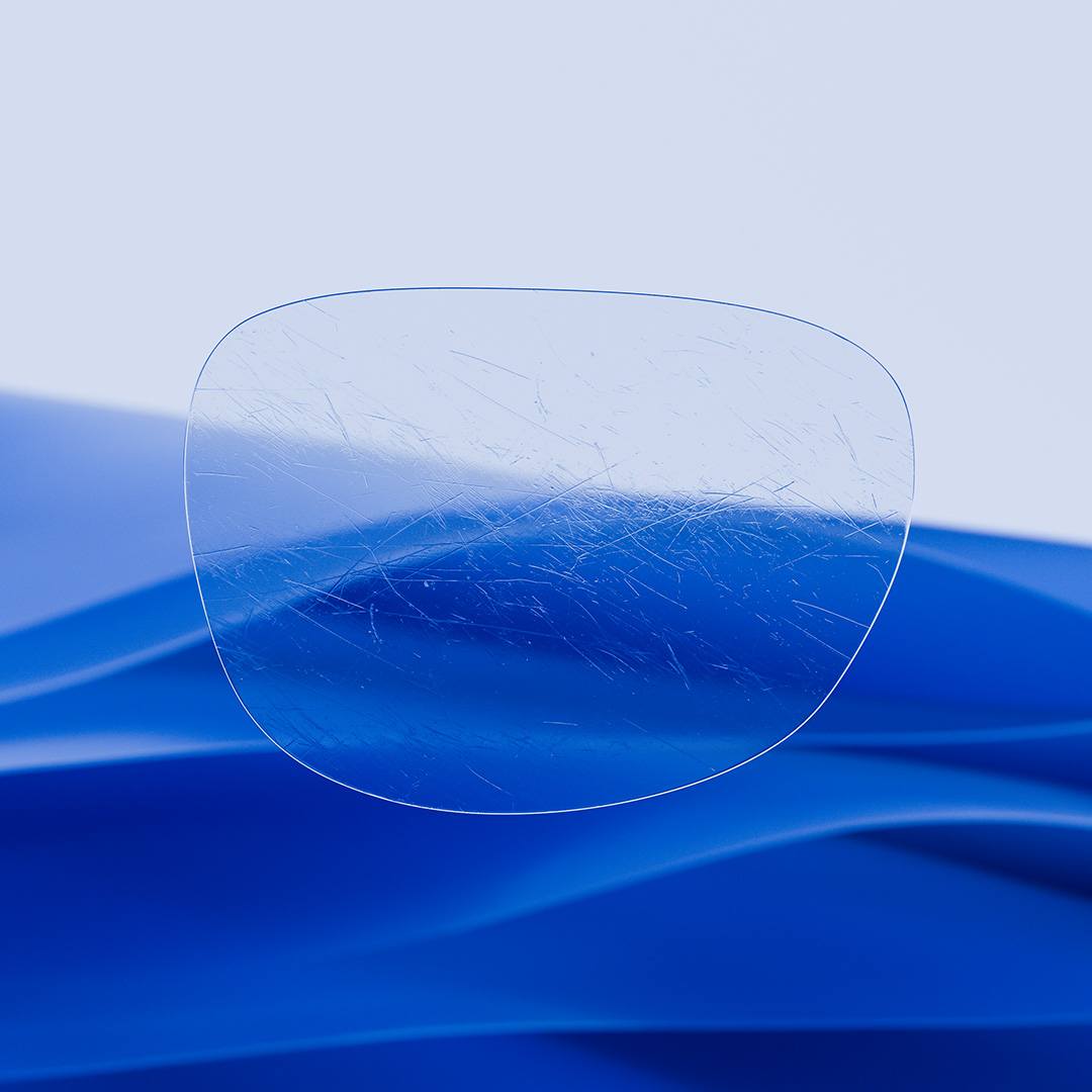 Een afbeelding met een gedeeld brillenglas waarvan de ene helft helder en schoon is dankzij ZEISS DuraVision, terwijl de andere helft vol zit met krassen.